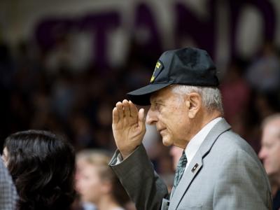 World War II Veteran renders a salute during the National Anthem